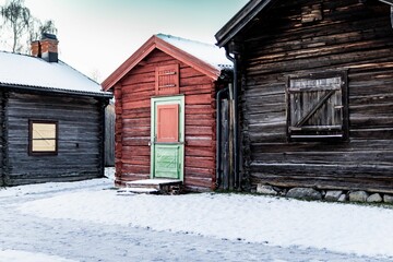 Old wooden brick homes in the center of a snow-covered residential area