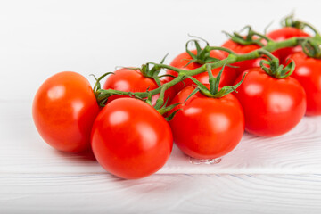 Tomatoes on  texture background. Cherry tomatoes on the kitchen table. Organic vegetables, harvesting.Vegan. Fresh ripe tomatoes. copy space.