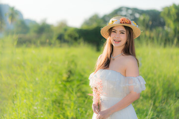 Asian woman in white dress skirt on nature background,Young woman traveler wear hat on nature background, mtravel concept