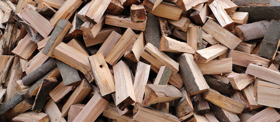 stacked dry firewood as a background - Powered by Adobe