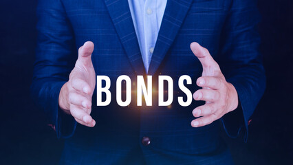 Businessman holding bonds virtual screen. Bond Finance Banking Technology concept, Trade Market Network, bond security that indicates the investor has provided loan the issuer, Equivalent loan