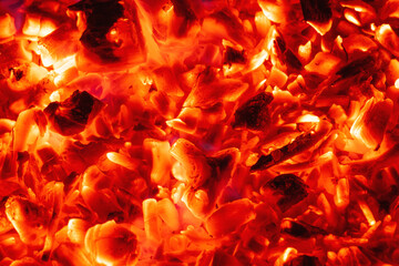 Smoldering charcoal in a bonfire, background texture