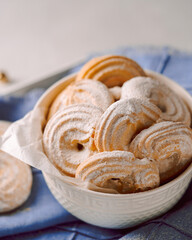 homemade textured cookies in a bowl, close-up, light blue background