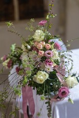 Aesthetically pleasing composition of pink flowers arranged on a crisp white tablecloth