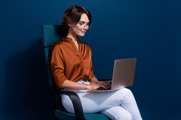 Photo portrait of pretty young girl sitting armchair work netbook wear trendy brown blouse isolated...