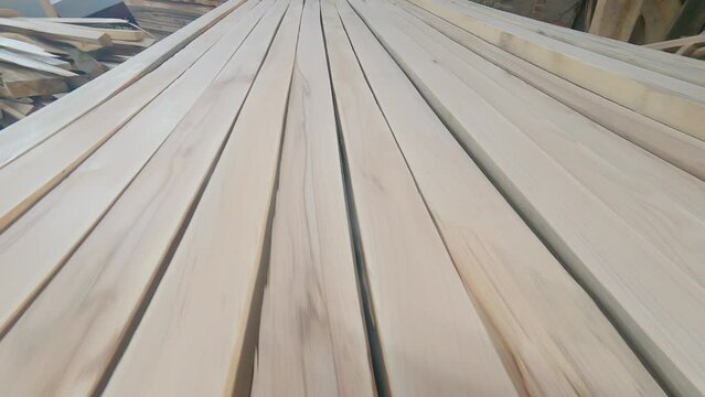 Wooden planks stacked in workshop. Joinery material for the manufacture of wood products