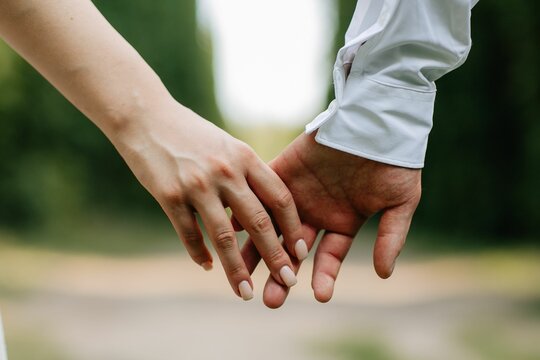 Closeup shot of a happy couple holding hands.