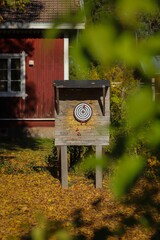 Wooden dart board displayed in a rural landscape in Finland
