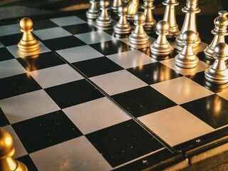 Classic chessboard with gold and silver pieces, ready to be used for a game
