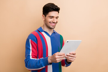 Photo of business data analytic browsing tablet answering his boss chat message about agreement details isolated on beige color background