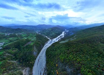 A panoramic aerial view of the Enza River near the village of Vetto d'Enza and the Vetto Dam. Reggio Emilia, Emilia Romagna, Italy