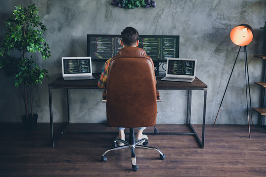 Full body rear behind portrait of skilled cyber security expert sit chair us pc laptop displays modern office indoors