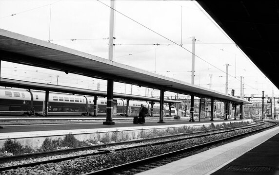 Black and white photograph of a train station platform in Paris, France