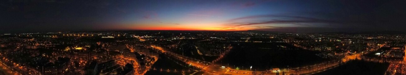 Aerial panoramic view of sunset over the bustling city