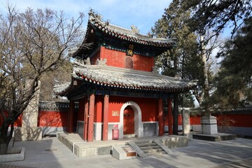 Traditional Chinese building surrounded by trees in National Heritage Site Jietai Temple, Beijing