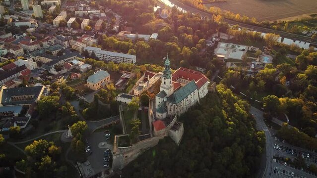 4k footage of Nitra Castle and streets of Nitra city on sunset - autumn time. Aerial view of beautiful and fairytale Nitra Castle.