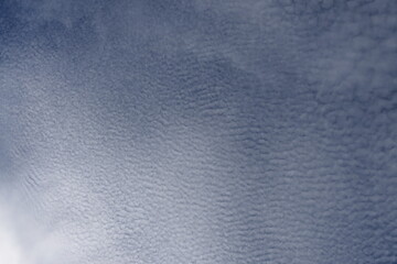 Natural sky with billowing clouds against a backdrop of vibrant blue.