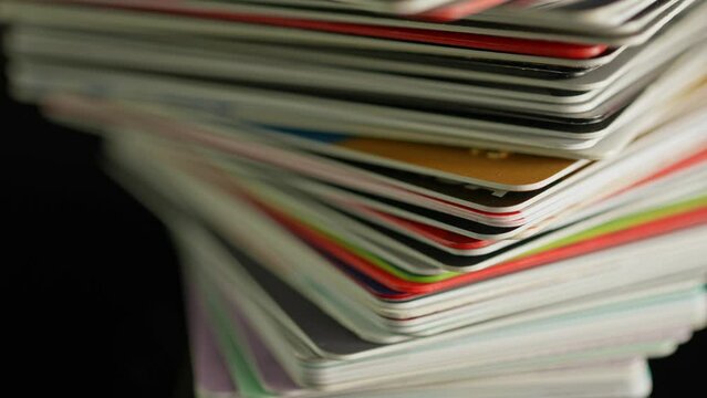 Credit cards pile close up macro. Means of payments for various purchases and business financial transactions. Online payment, cash withdrawal, financial operations, shopping, money transfer.
