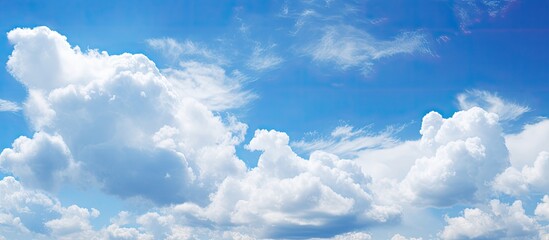 A background of white clouds against a blue sky - obrazy, fototapety, plakaty