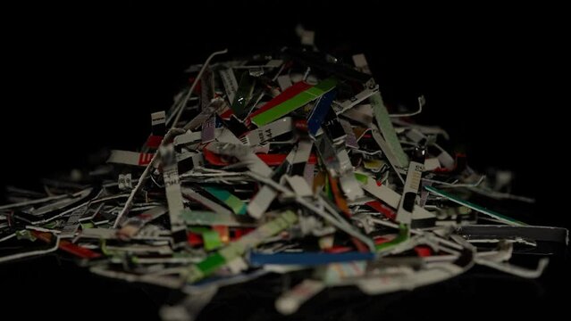 Credit cards pile shredded and cut. Remains of plastic credit cards after expiration or debt consolidation, disposed. Scattered pieces of bank cards. Line of credits, inflation of high interest rates.