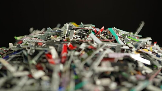 Shredded credit cards and money in bank accounts. Pile of cut bank credit cards as cashless payments technology. Balance due, bankruptcy and debt consolidation. Personal banking and credit.