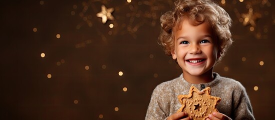 A small child grasps a cookie adorned with decorations - Powered by Adobe