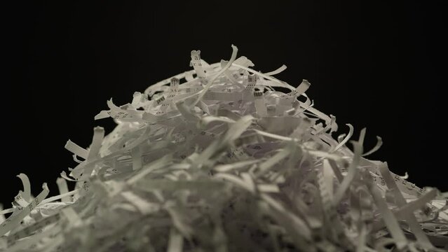 Shredded sensitive information documents with lorem ipsum text, safeguarding against unauthorized access and potential breaches. Security measure and legal compliance.