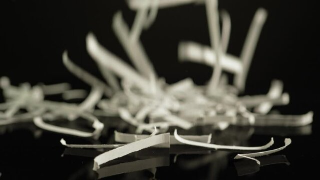 Shredded confidential paper documents. Office papers with sensitive information got destroyed. Preventative measures to fight identity thief and top secret documents leakage.