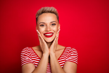 Photo of adorable lovely girl wearing bright clothes admiring holiday visage red lips isolated on red color background