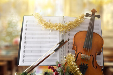 Violin with christmas decoration with religious temple background