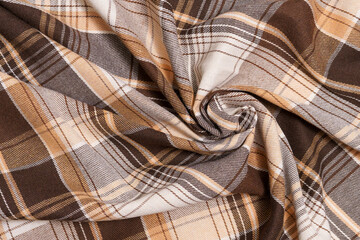 Twisted warm tartan fabric in brown and beige colors. Material for sewing shirts, skirts....