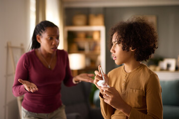 Teenage boy caught up with cigarette at home- concept of underage smoking