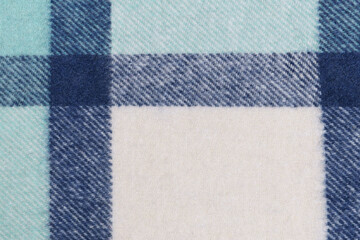 close-up texture blue milky warm fabric in a tartan cell. Background for your design