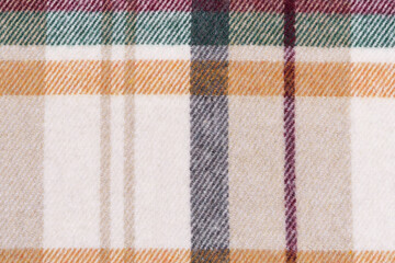 texture of a traditional scotch check in beige, yellow and green colors close-up. tartan for shirts and warm clothes. Image for your design