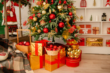 Christmas decoration, tree with red and gold toys. Interior decoration for the holiday.