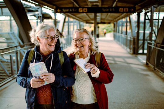 Senior women holding map at the train station
