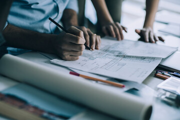 Close up of architect sketching a construction project in a office