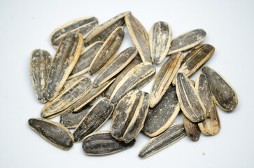 Sunflower seeds on white background, closeup of sunflower seeds