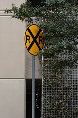 Yellow road sign situated outside of a building, possibly to warn or inform passersby