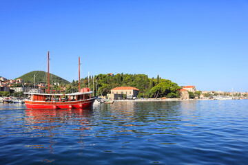 Marina with red ship in sunny day in Dubrovnik, Croatia 