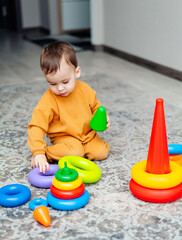 A Playful Toddler Engaged in Imaginative Play. A toddler playing with toys on the floor