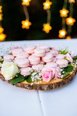 Wooden table with a variety of delicious pink-colored cookies on top of its surface