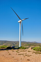 Wind turbines on beautiful sunny summer mountain landscape. Green ecological power energy generation. Bunol wind farm, Spain.