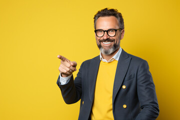portrait of a man waving in front of a yellow background  - Powered by Adobe
