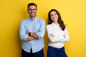 portrait of a man and a woman in front of a yellow background. team, ensemble, company - obrazy, fototapety, plakaty