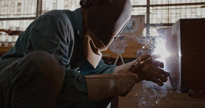 Mechanic welding in workshop