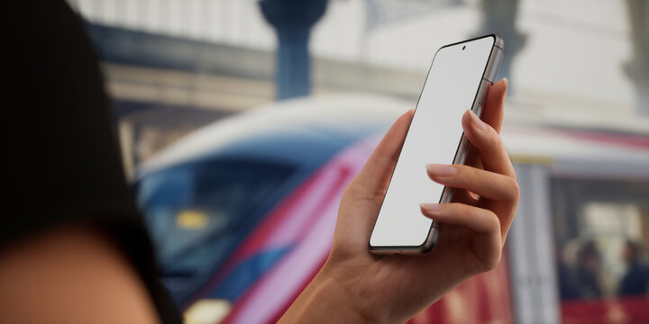 CU view of Caucasain female using her phone on a train station platform