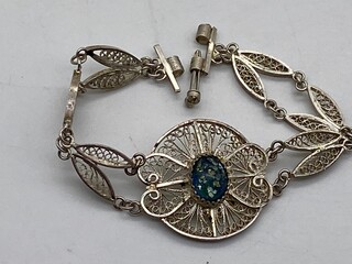 Closeup of a silver bracelet with an intricate design