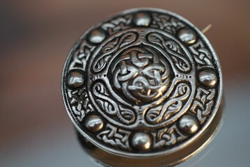 Closeup of an intricate, creative brooch