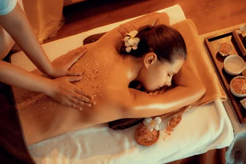 Deurstickers Woman customer having exfoliation treatment in luxury spa salon with warmth candle light ambient. Salt scrub beauty treatment in Health spa body scrub. Quiescent © Summit Art Creations